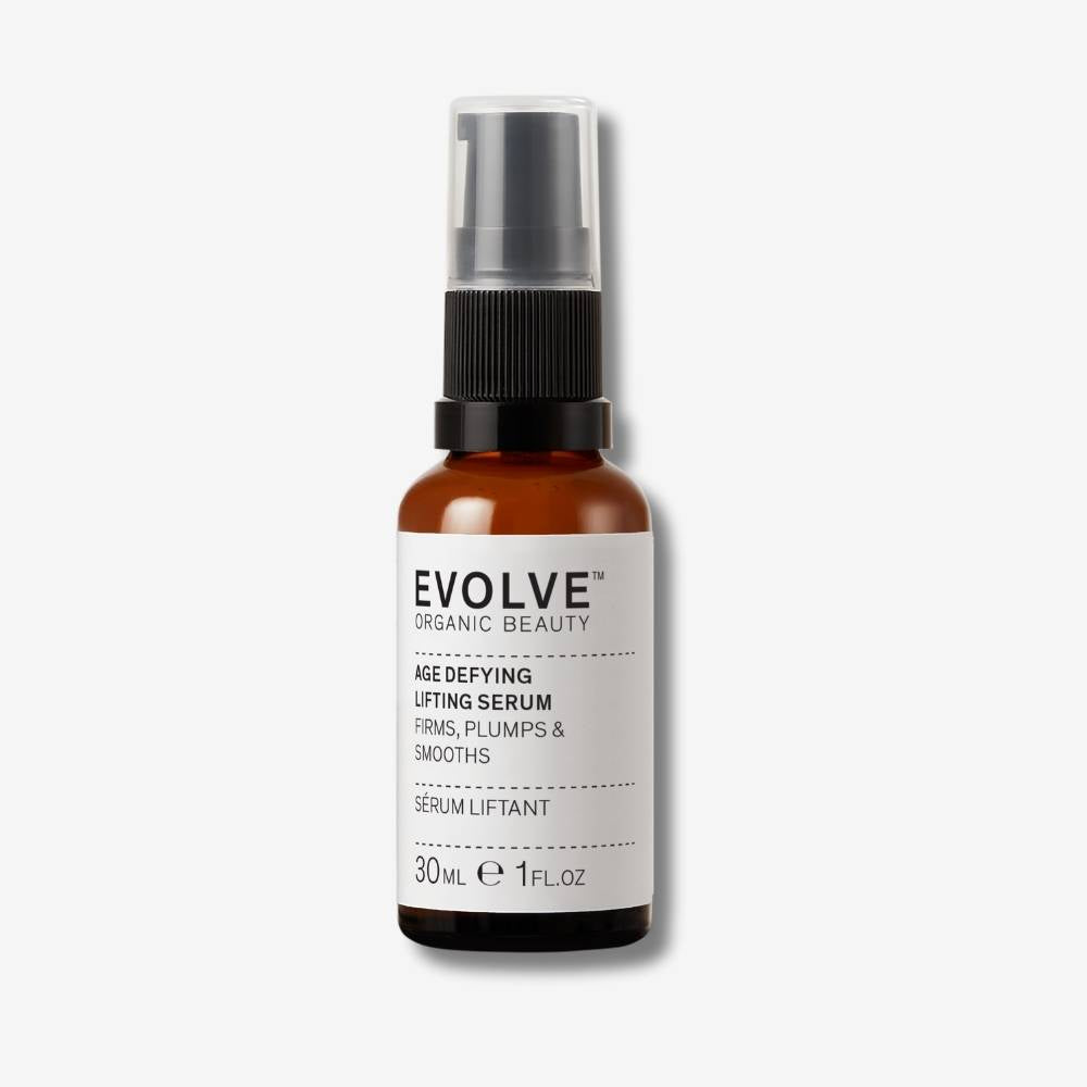 Evolve Organic Beauty Age defying lifting serum in brown glass bottle with black pump lid on off white background with shadow behind