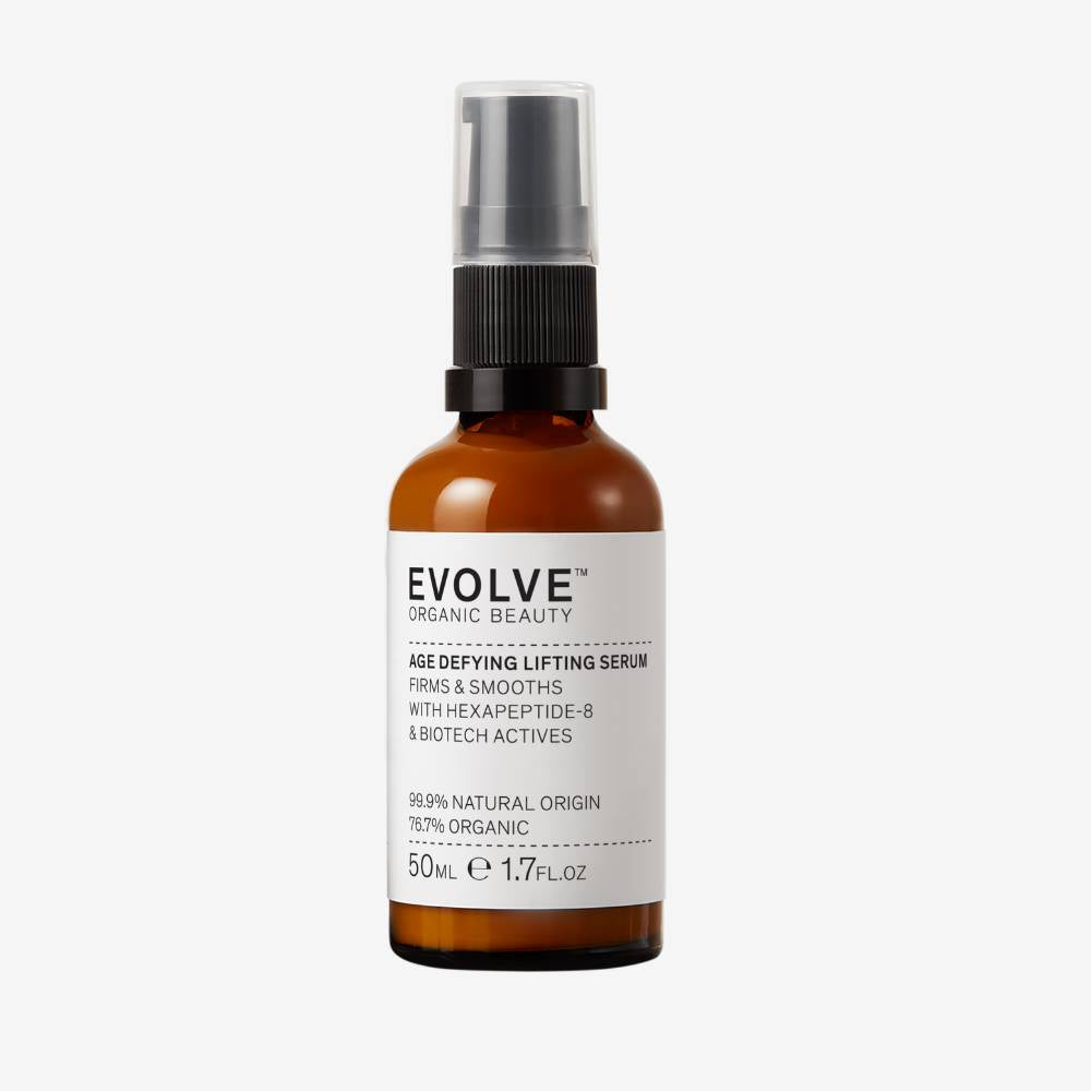Evolve Organic Beauty Age defying lifting serum in brown glass bottle with black pump lid on off white background with shadow behind