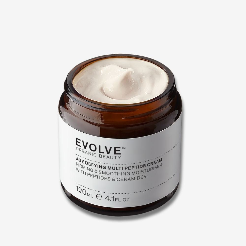 Evolve Organic Beauty Age defying multi peptide cream in brown glass jar on off white background with shadow behind