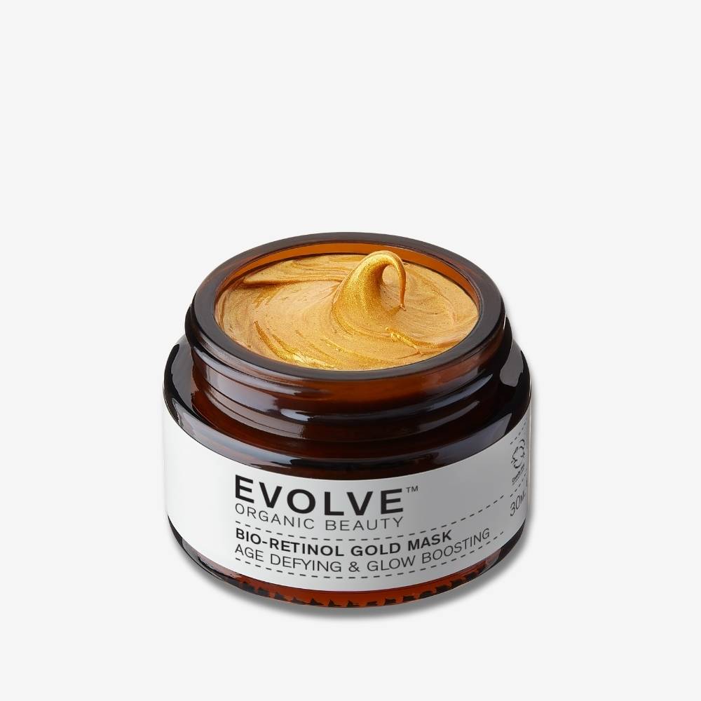 Evolve Organic Beauty Bio-Retinol Gold Mask in brown glass jar whit gold texture swirl on off white background with shadow behind