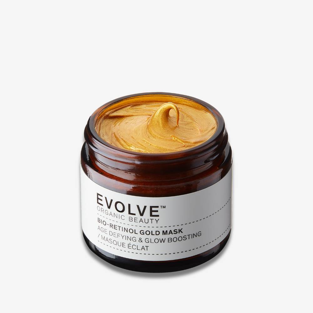 Evolve Organic Beauty Bio-Retinol Gold Mask in brown glass jar whit gold texture swirl on off white background with shadow behind