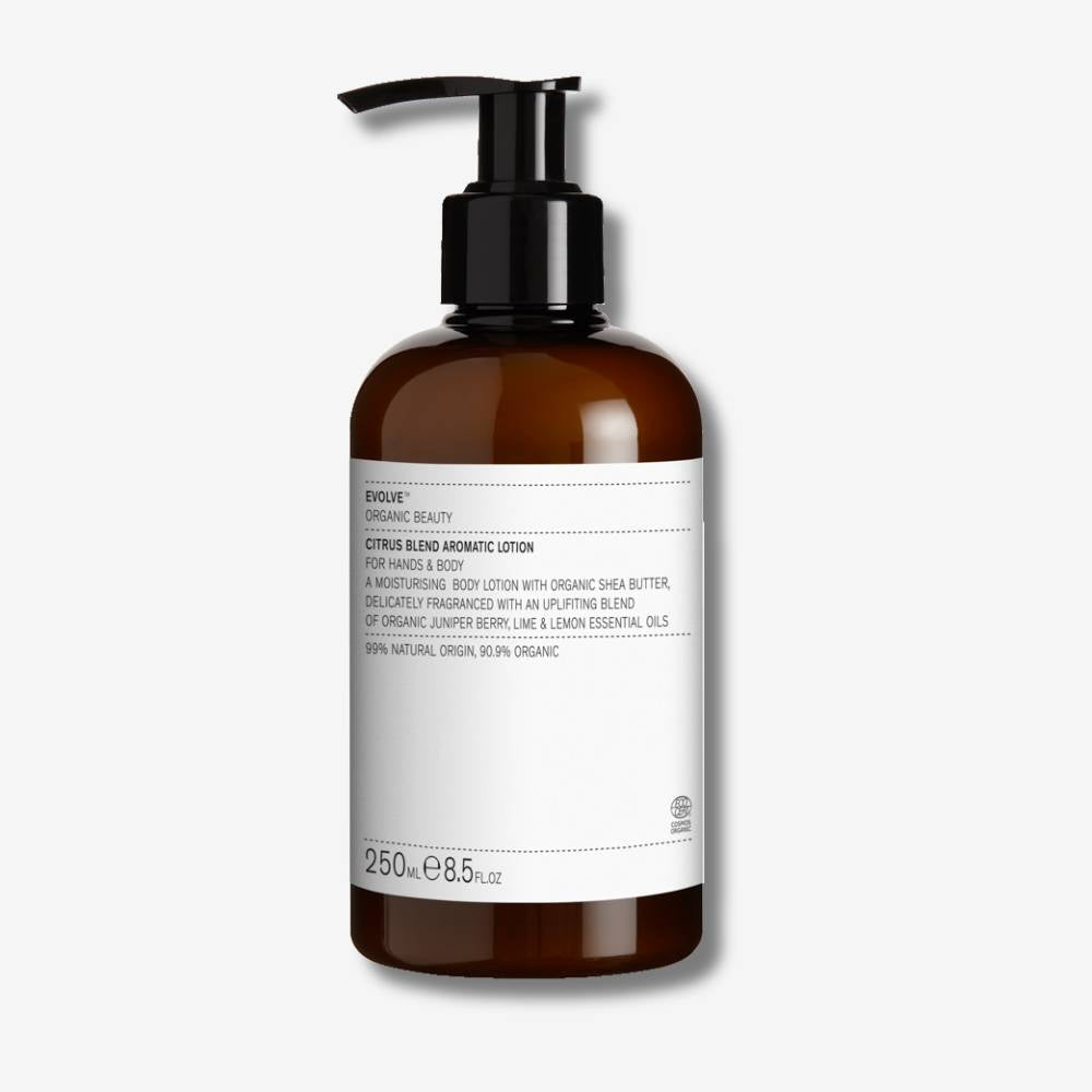 Evolve Organic Beauty Citrus Blend Aromatic Lotion in brown bottle with black pump lid on off white background with shadow behind