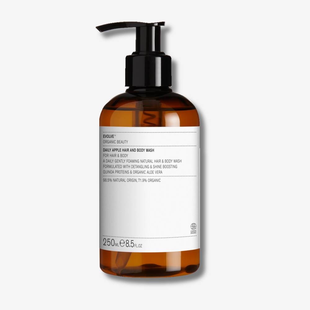 Evolve Organic Beauty Daily Apple Hair and Body Wash in brown bottle with black pump on off white background with shadow behind