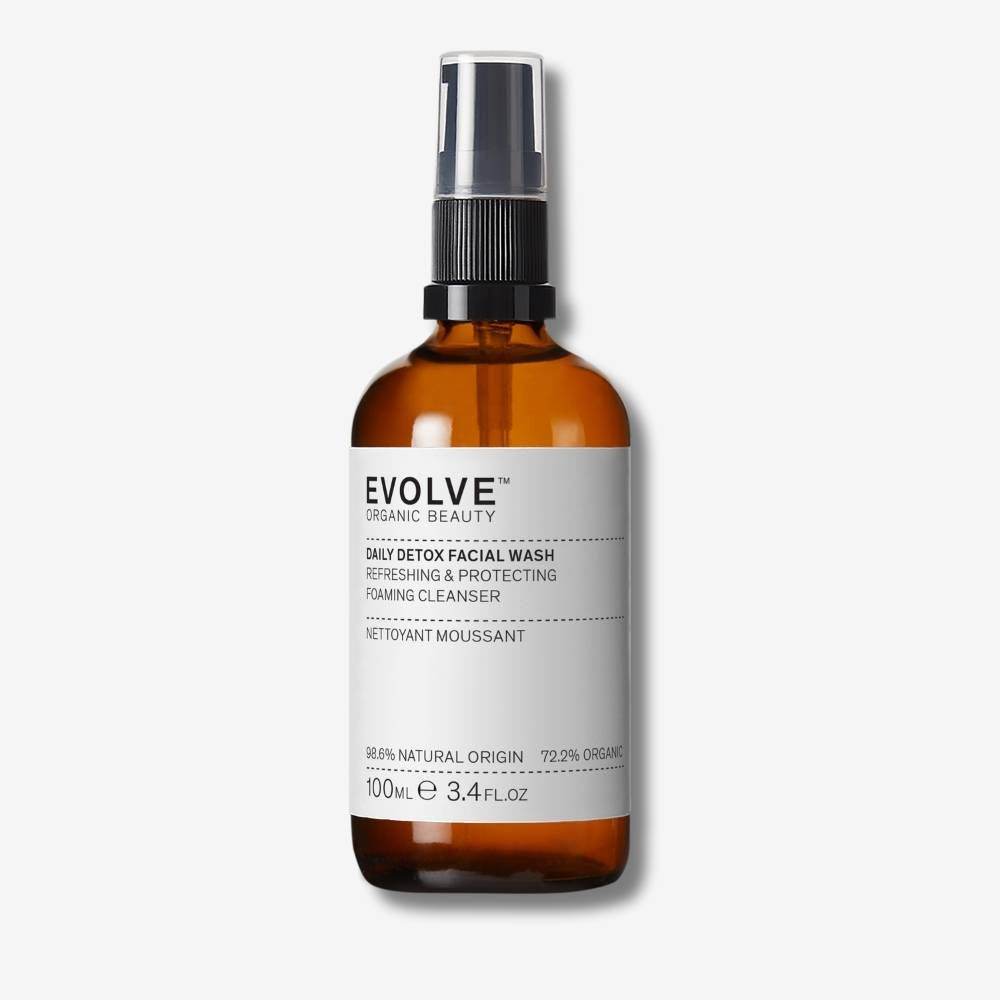 Evolve Organic Beauty Daily Detox Facial Wash in brown glass bottle with black pump lid on off white background with shadow behind