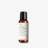 Evolve Organic Beauty Deep Clean Micellar Water in brown travel size bottle with black lid on off white background with shadow behind