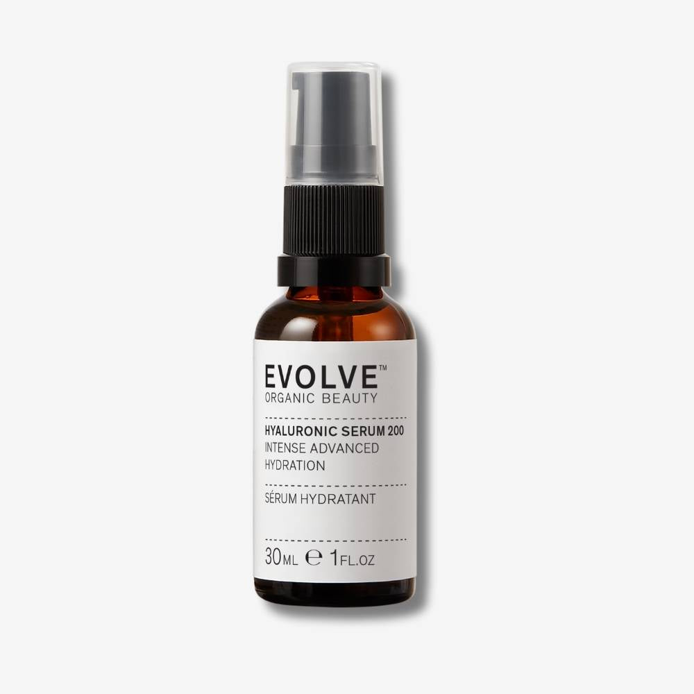 Evolve Organic Beauty Hyaluronic Serum 200 in brown glass bottle with black pump lid on off white background with shadow behind
