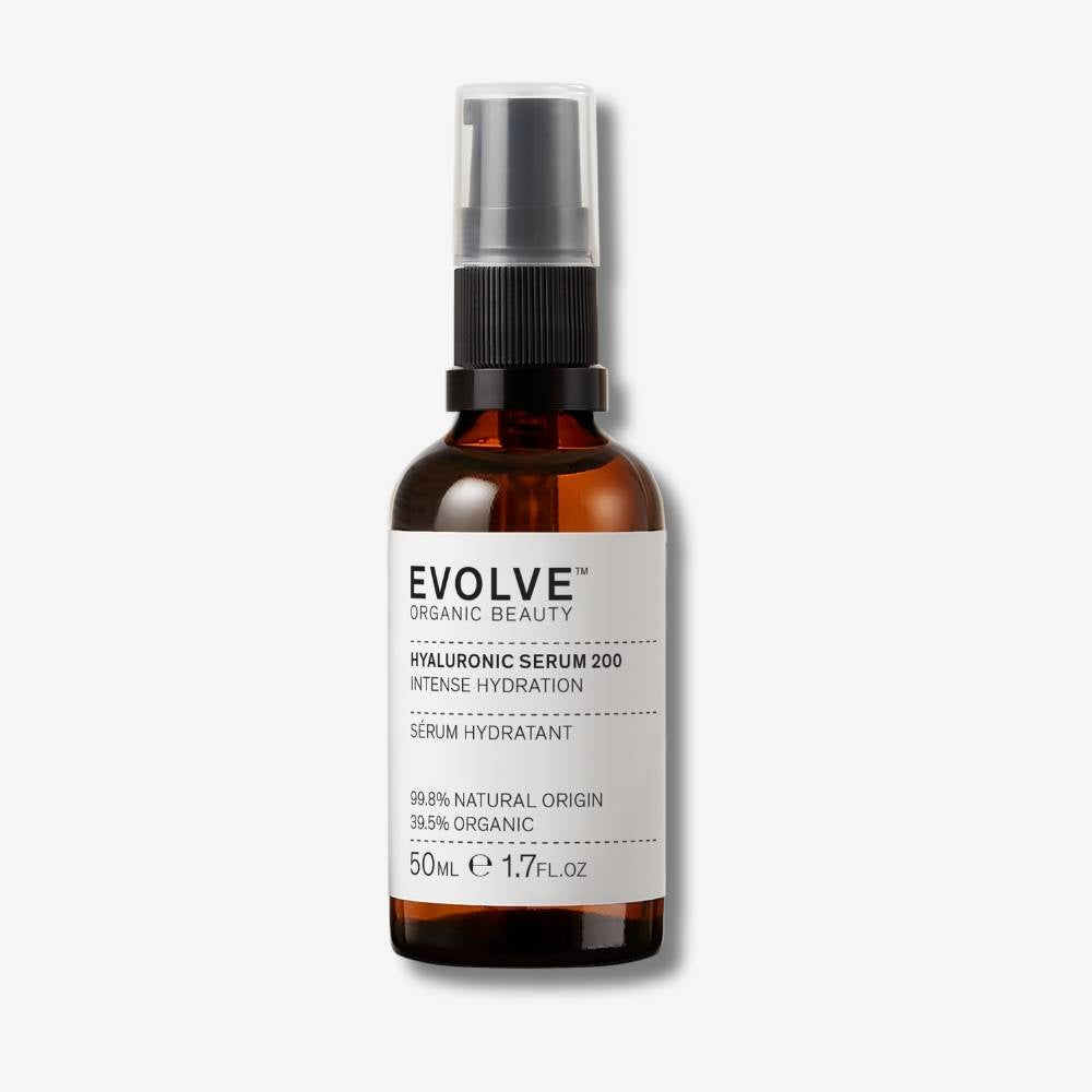 Evolve Organic Beauty Hyaluronic Serum 200 in brown glass bottle with black pump lid on off white background with shadow behind