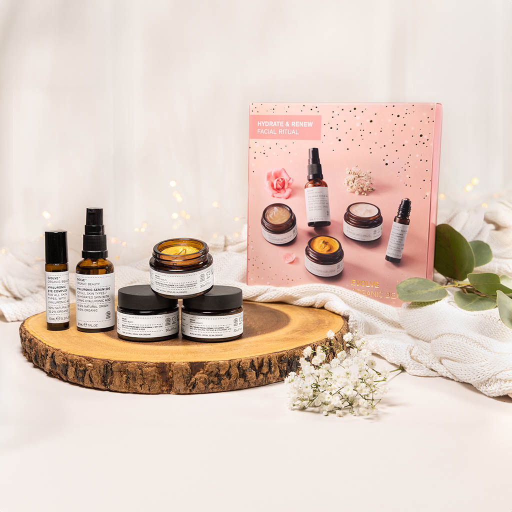 hydrate and renew facial ritual gift set on cosy blankets with wooden circle and flowers