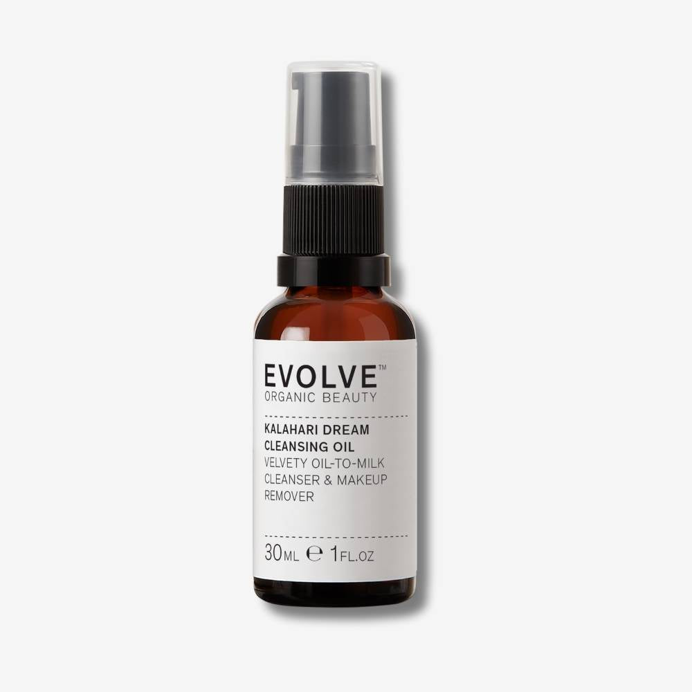 Evolve Organic Beauty Kalahari Dream Cleansing Oil in brown glass bottle with black pump lid on off white background with shadow behind