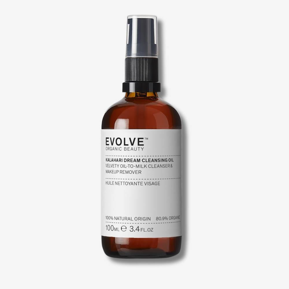 Evolve Organic Beauty Kalahari Dream Cleansing Oil in a brown bottle with black pump lid on off white background with shadow behind