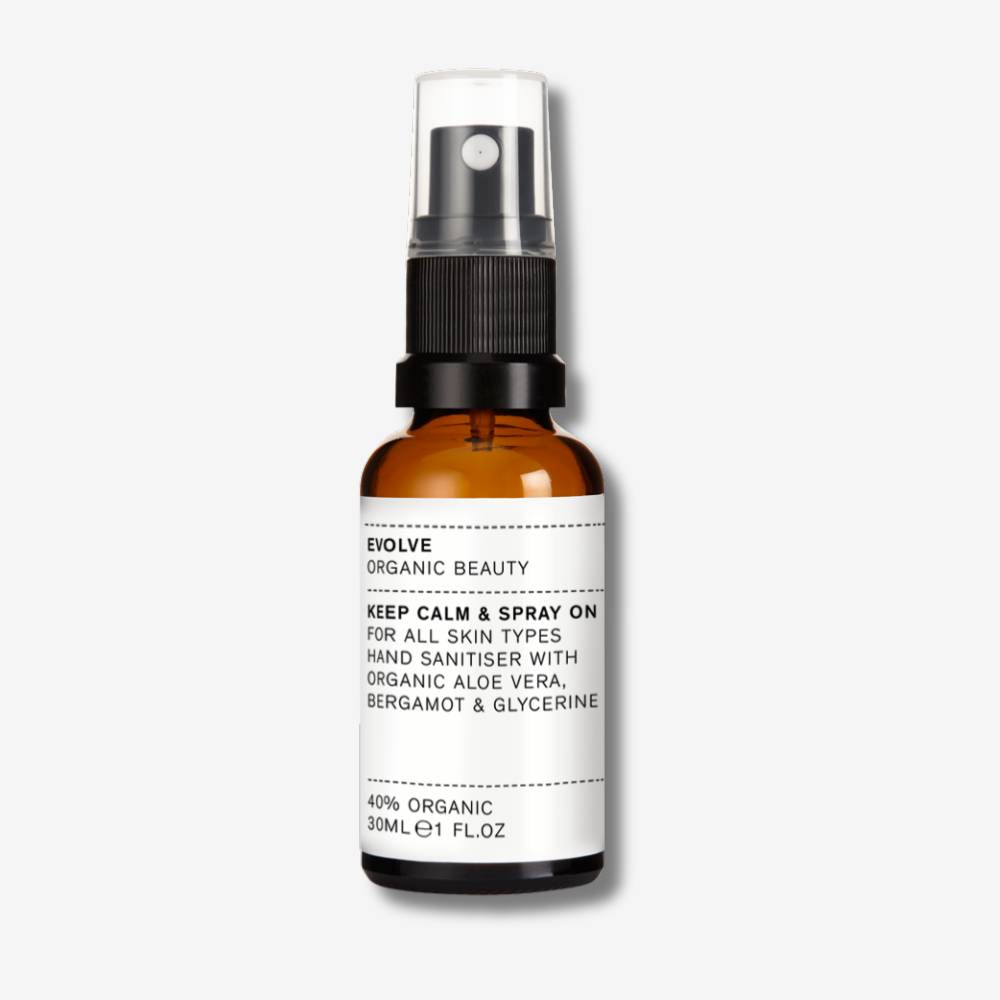 Evolve Organic Beauty Keep Calm & Spray On in brown glass bottle with black spray lid on off white background with shadow behind