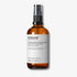 Evolve Organic Beauty Liquid Radiance Glycolic Toner in brown glass bottle with black pump lid on off white background with shadow behind