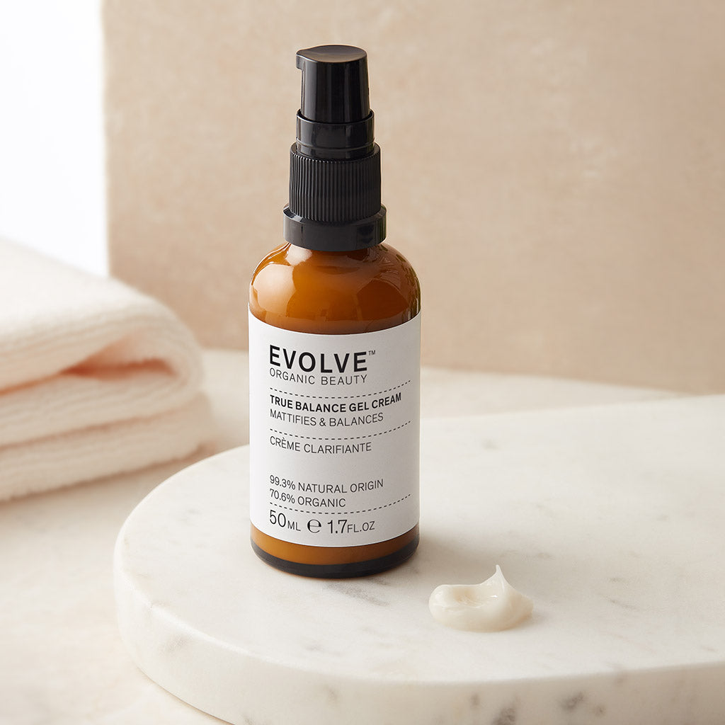 Bottle of True Balance Gel Cream on a marble tray with a swatch of cream next to it.