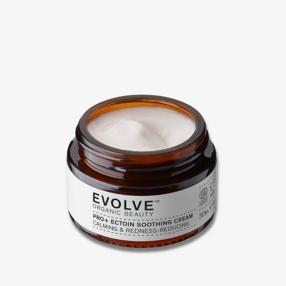 Travel sized Nightly Renew Facial Cream open jar on off white background with shadow behind