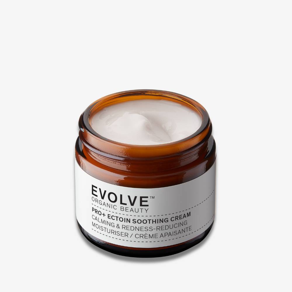 Nightly Renew Facial Cream open jar on off white background with shadow behind