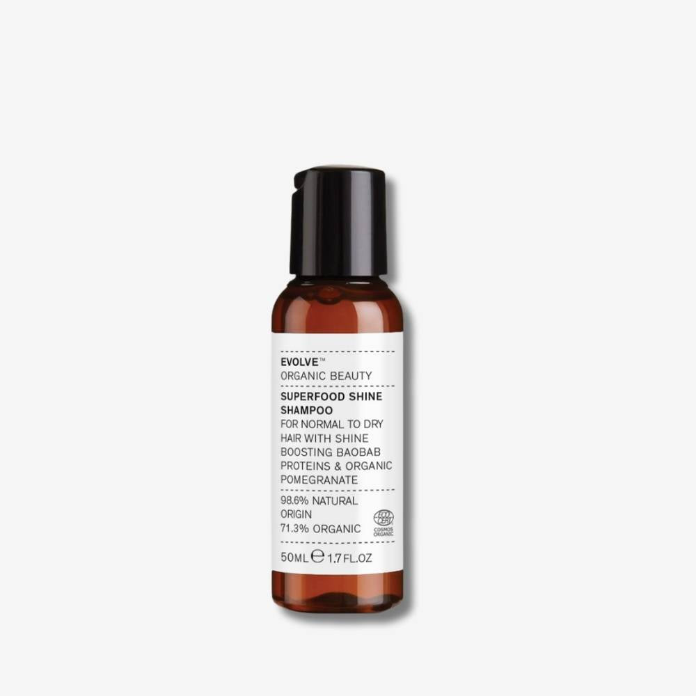 Evolve Organic Beauty Superfood Shine Shampoo 50ml brown bottle with black disc cap lid on off-white background with shadow behind
