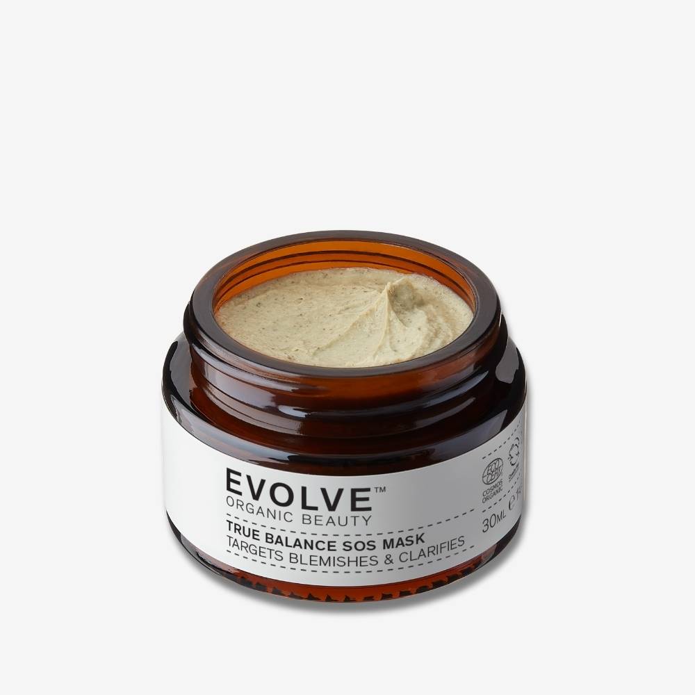 Evolve Organic Beauty travel sized true balance sos mask in open amber glass jar showing green texture on off white background