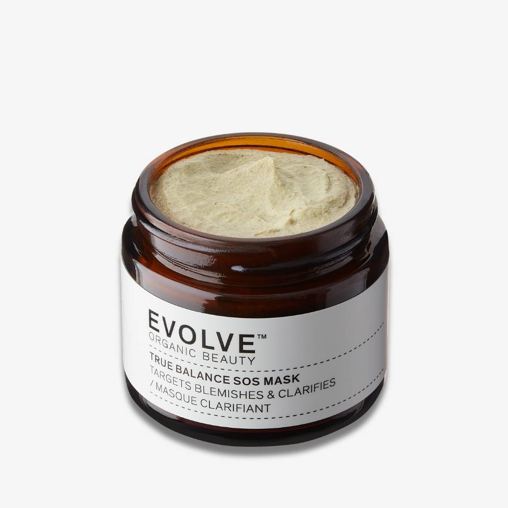 Evolve Organic Beauty true balance sos mask in open amber glass jar showing green texture on off white background
