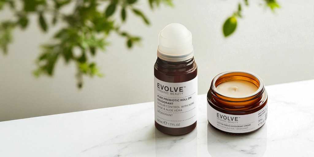 image of two natural deodorants from evolve organic beauty sat on white marble counter