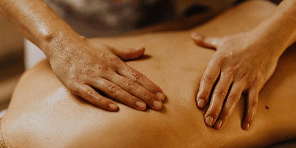 hands massaging someones back