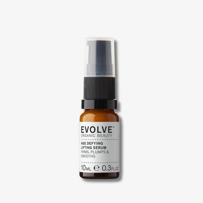 Evolve Organic Beauty Age defying lifting serum in brown glass bottle with black pump lid on off white background with shadow behind