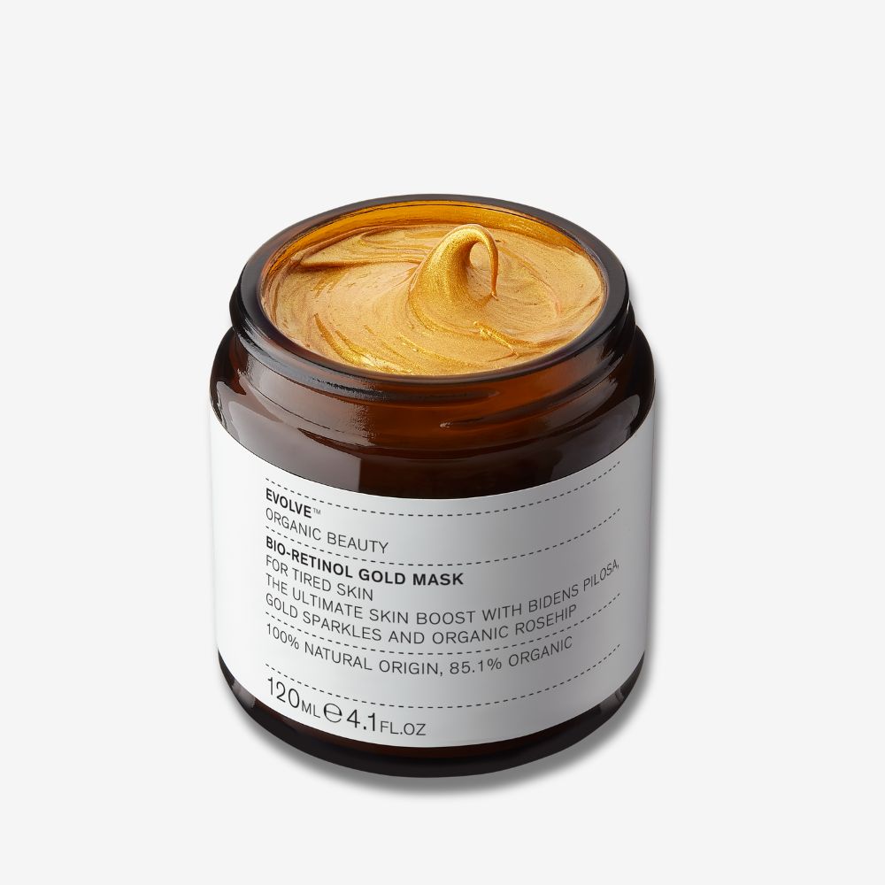 Evolve Organic Beauty Bio-Retinol Gold Mask in an open brown glass jar on off white background with shadow behind