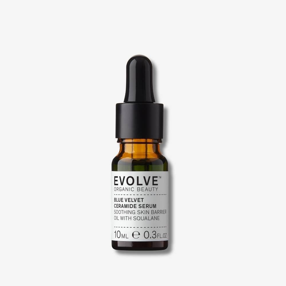 Evolve Organic Beauty Blue Velvet Ceramide Serum in brown glass travel size bottle with black pipette lid on off white background with shadow behind