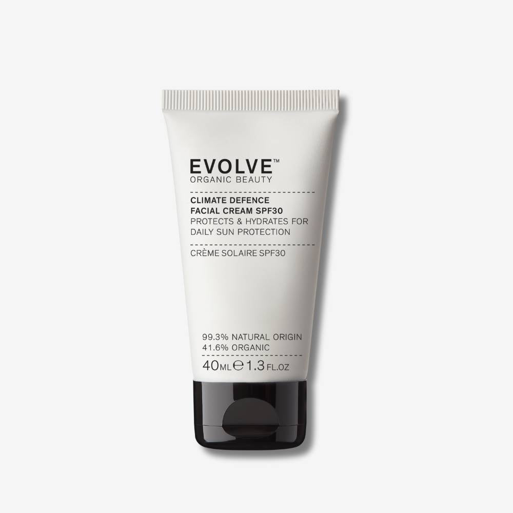 Evolve Organic Beauty Climate Defence SPF 30 in a beige tube with black cap on an off white background with shadow behind