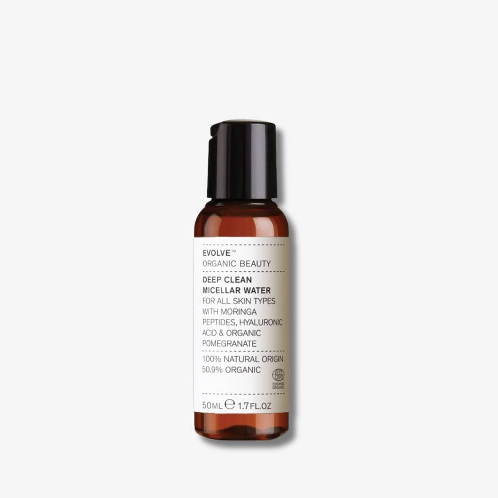 Evolve Organic Beauty Deep Clean Micellar Water in brown travel size bottle with black lid on off white background with shadow behind