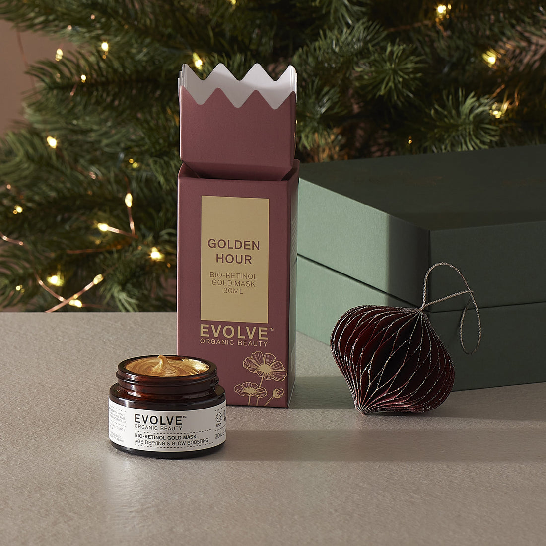 Evolve Organic Beauty Bio-retinol gold mask with Christmas packaging and decorations in the background