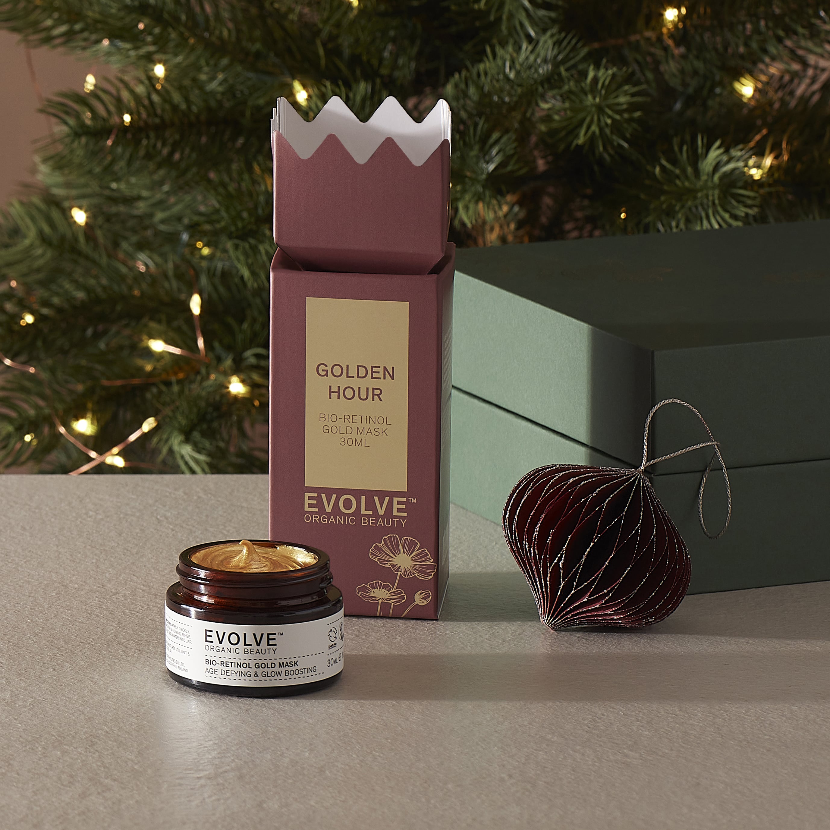 Evolve Organic Beauty Bio-retinol gold mask with Christmas packaging and decorations in the background