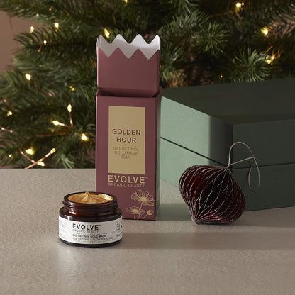 Evolve Organic Beauty Bio-retinol gold mask with Christmas packaging and decorations in the background