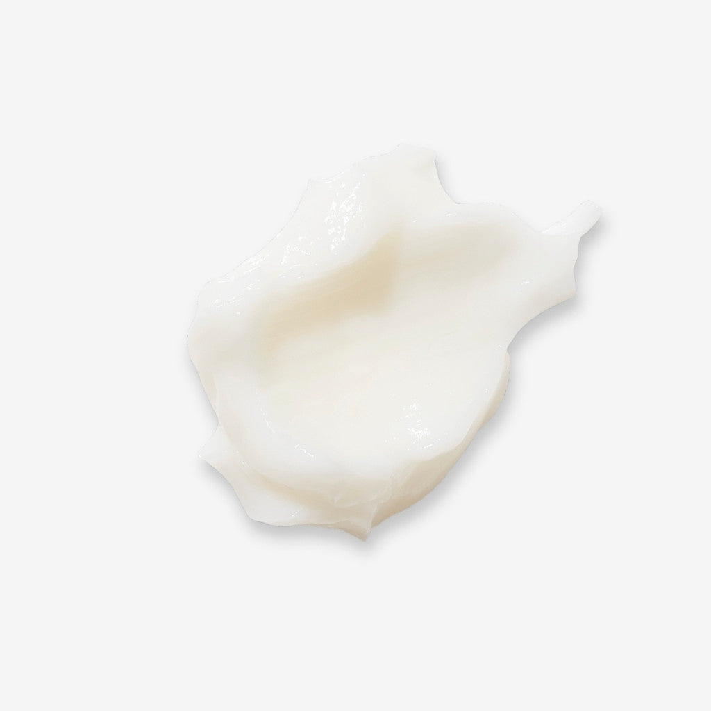 Swatch of Monoi Rescue Conditioner on an off-white background