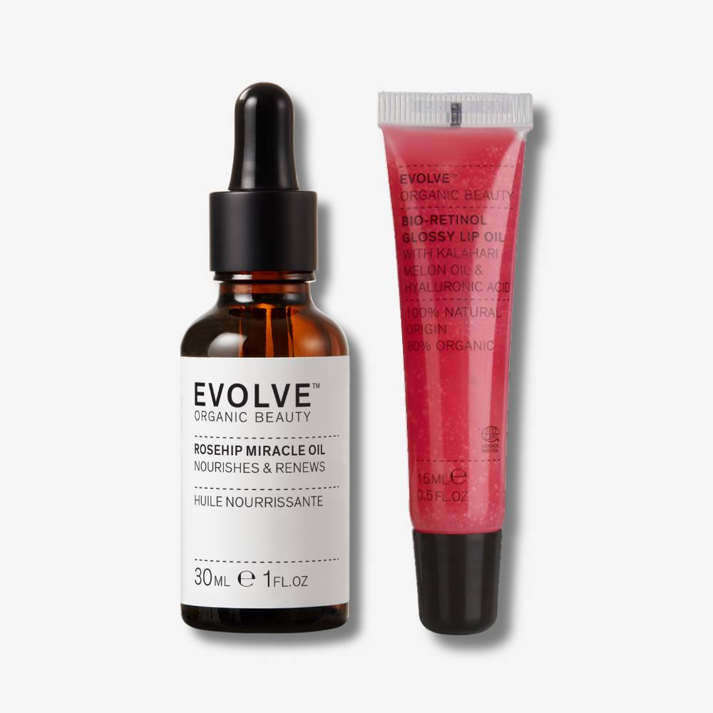 evolve organic beauty packshot of rosehip miracle oil next to bio-retinol glossy lip oil on off white background