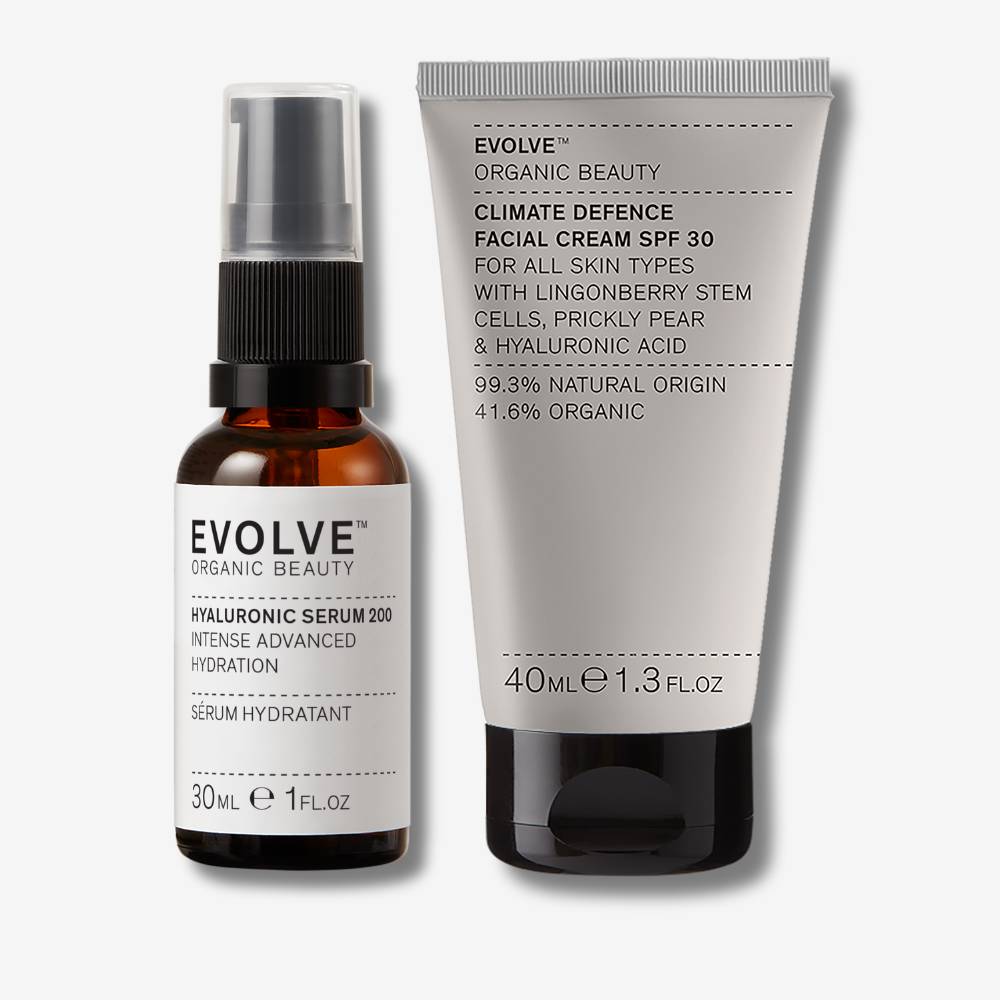 evolve organic beauty packshot of hyaluronic serum 200 next to climate defence spf facial cream on off white background