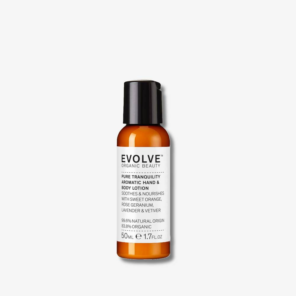 Evolve Organic Beauty Pure tranquility aromatic hand and body lotion travel size in brown  plastic bottle with black lid on off white background with shadow behind