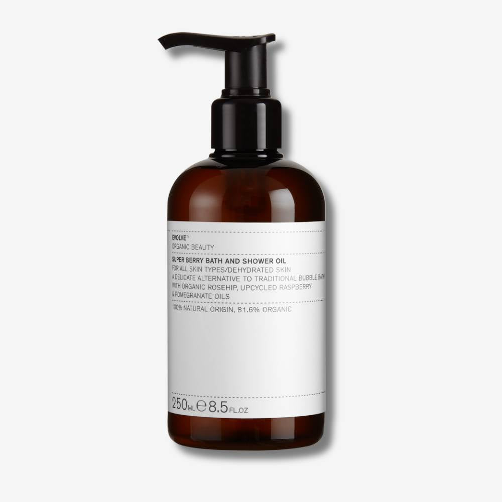 Evolve Organic Beauty Super Berry Bath &amp; Shower Oil in brown bottle with pump lid on off white background with shadow behind