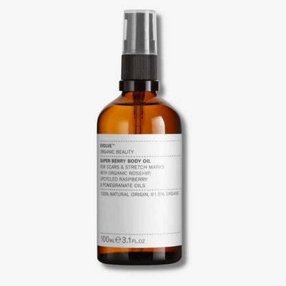 Evolve Organic Beauty Super Berry Body Oil  in brown glass bottle with black pump lid on off white background with shadow behind