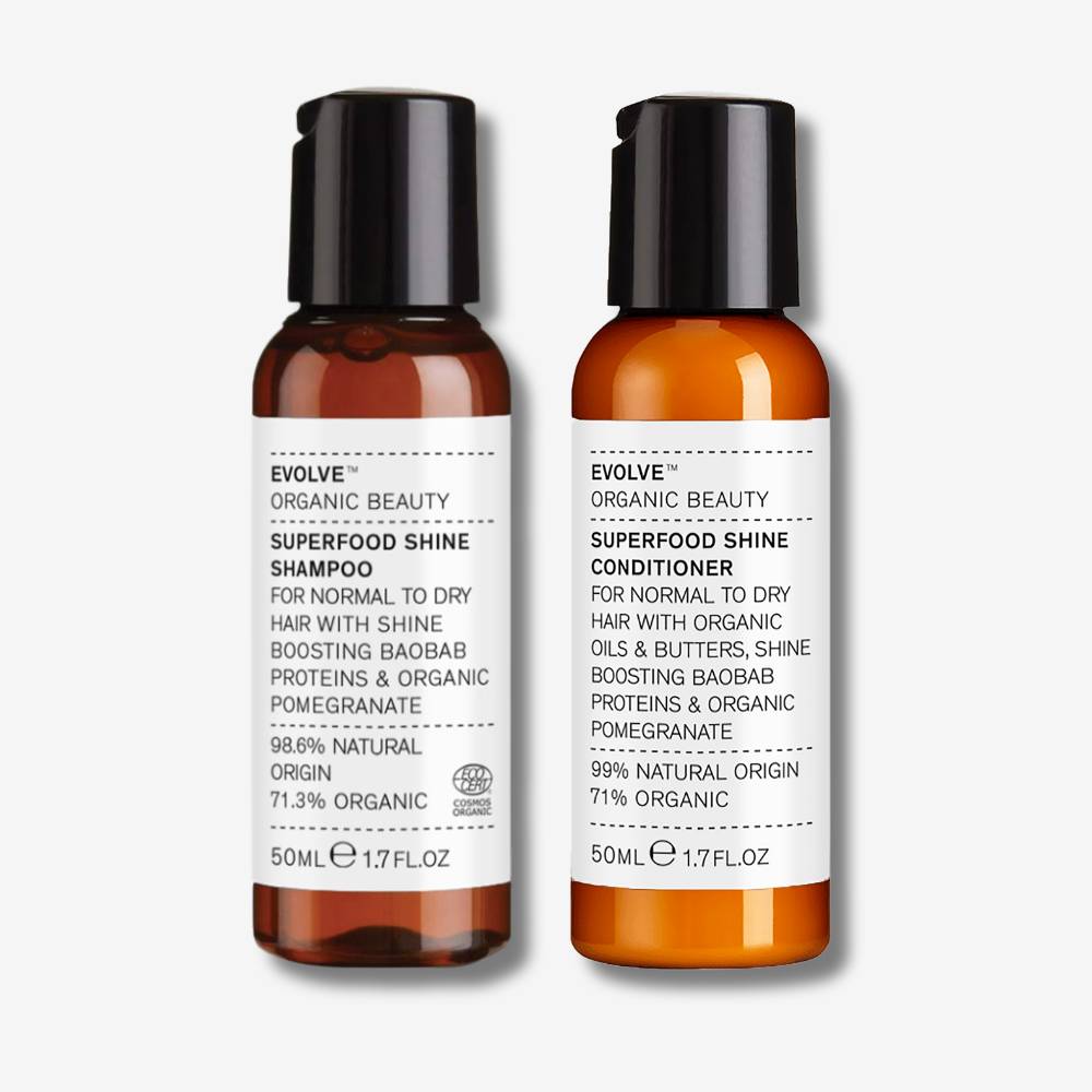 evolve organic beauty packshot of travel size superfood shine shampoo and travel sized superfood shine conditioner on off white background