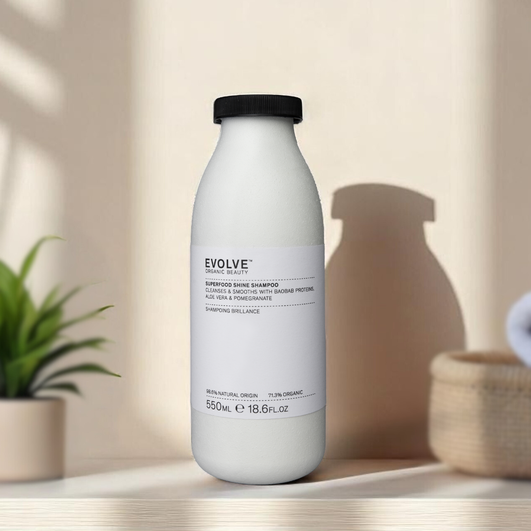 superfood shine shampoo in fiber based recyclable bottle on wooden table with white towels and plant