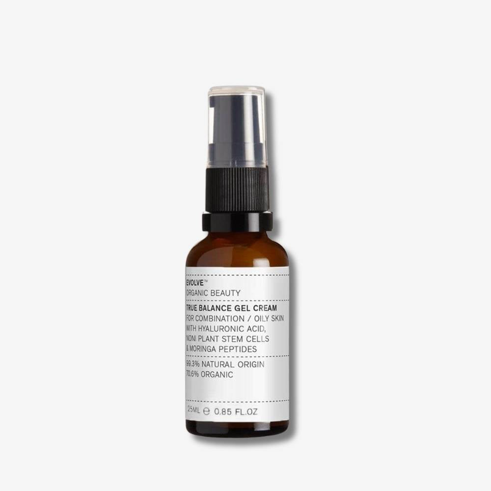 Travel sized Evolve Organic Beauty True Balance Gel Cream in brown glass bottle with black pump lid on off white background with shadow behind