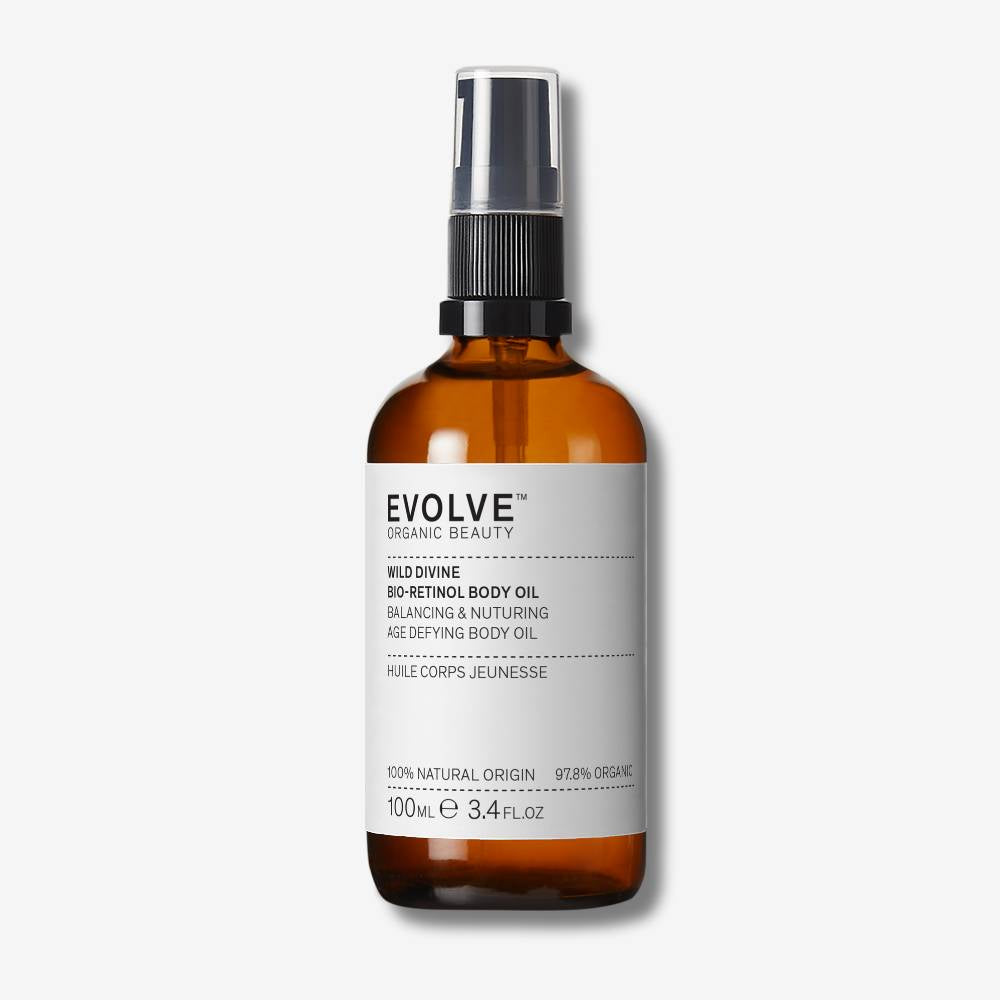 Evolve Organic Beauty Wild Divine bio-retinol body oil  in brown Prevented ocean plastic bottle with black pump on off white background with shadow behind