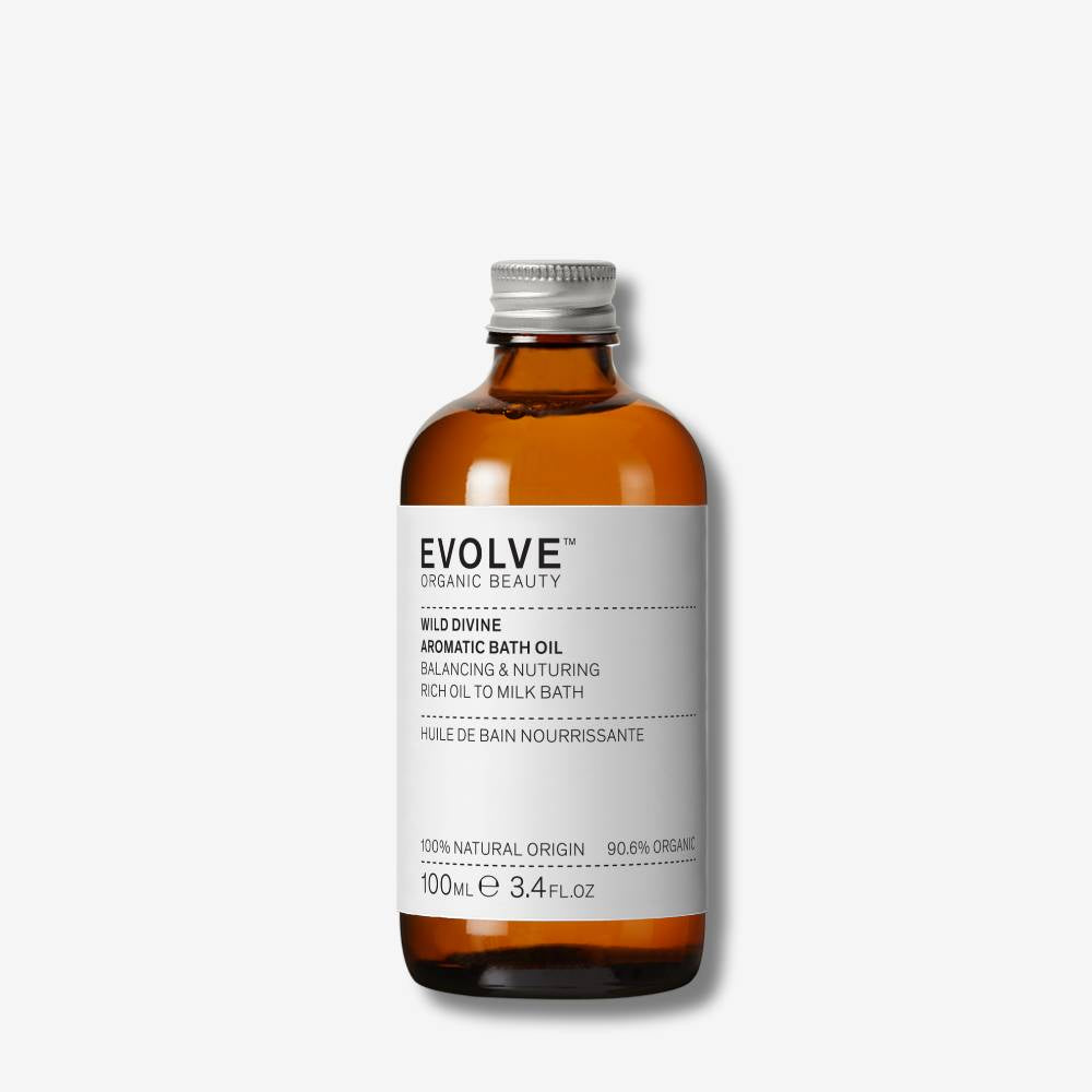 Bottle of Evolve Organic Beauty Wild Divine Aromatic Bath Oil on a white background